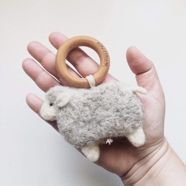 gyapjúból készült bárány alakú rágóka kézben